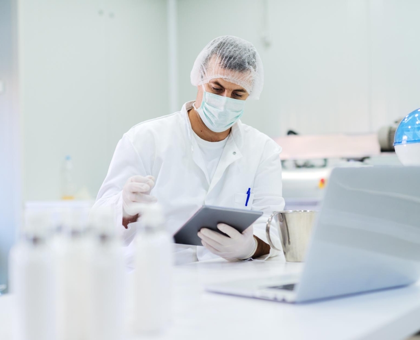 Worker inspecting quality of soap product