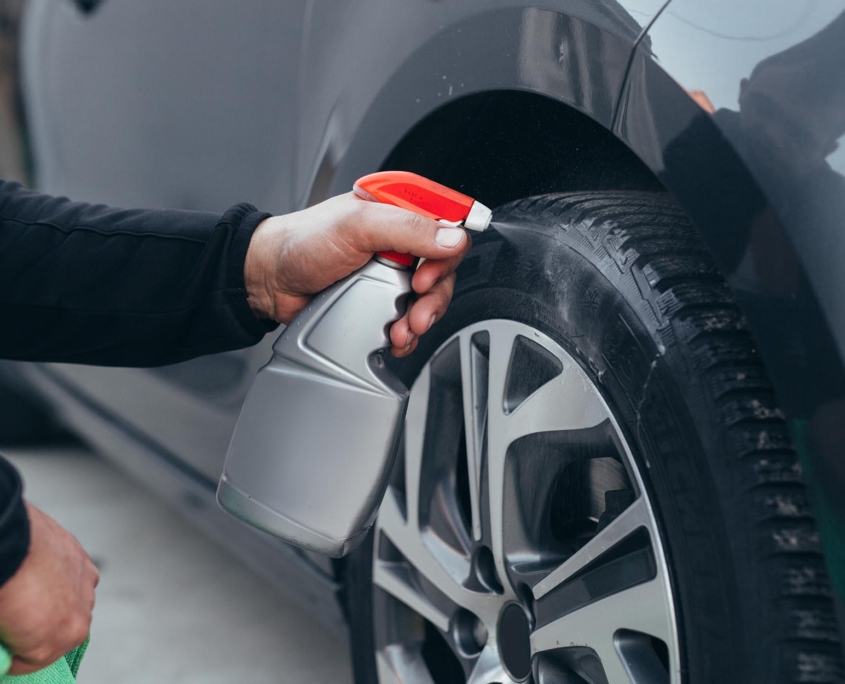 Person using cleaning chemicals to shine car tires