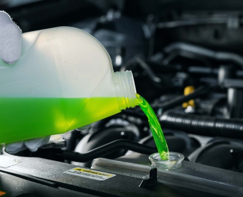 Person filling car with antifreeze