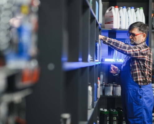 Worker stocking automotive products on shelf