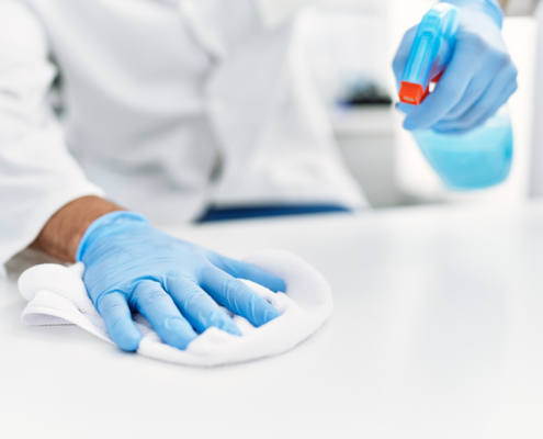 man working as scientific cleaning the table at laboratory