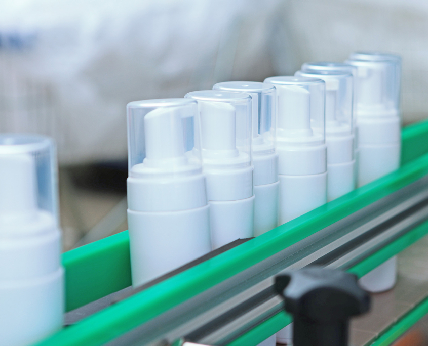 White plastic bottles move along the conveyor belt