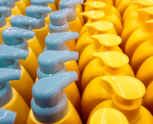 Color plastic bottles with lids in a row