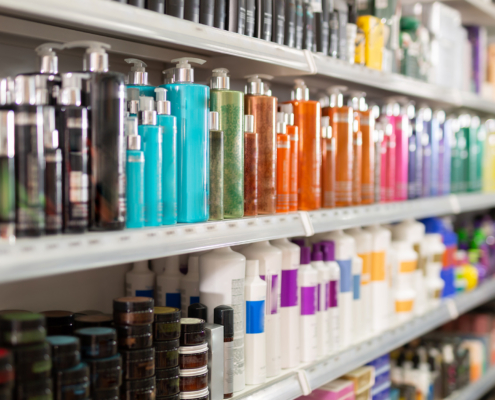 Colorful fashionable modern showcase in cosmetic boutique with variety of hair care products