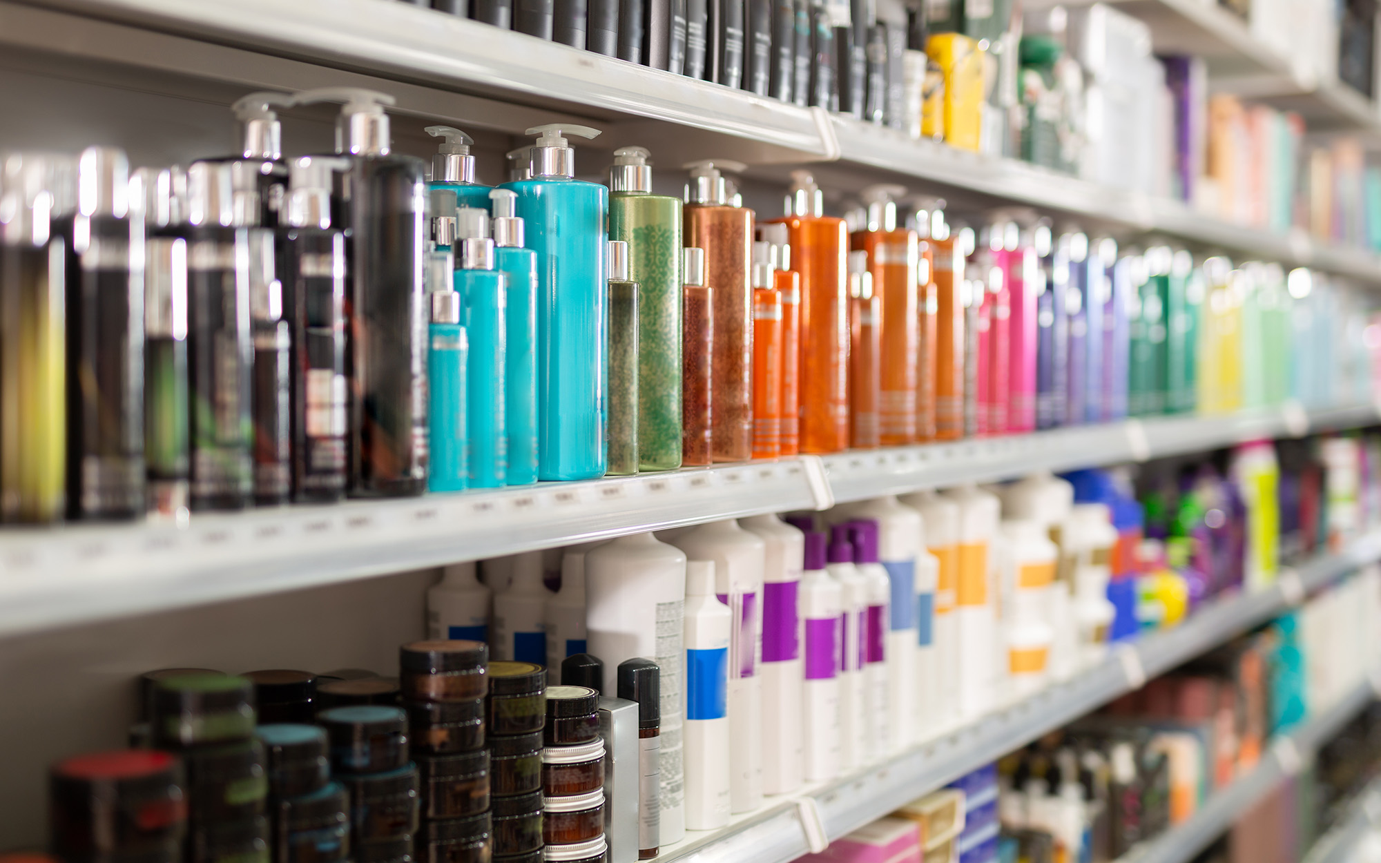 Colorful fashionable modern showcase in cosmetic boutique with variety of hair care products Colorful fashionable modern showcase in cosmetic boutique with variety of hair care products