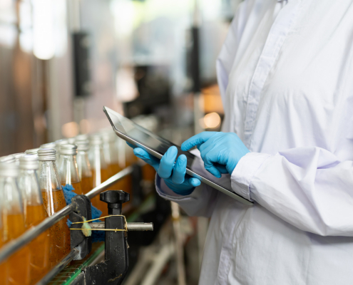 Hands of worker working with digital tablet check product on the conveyor belt
