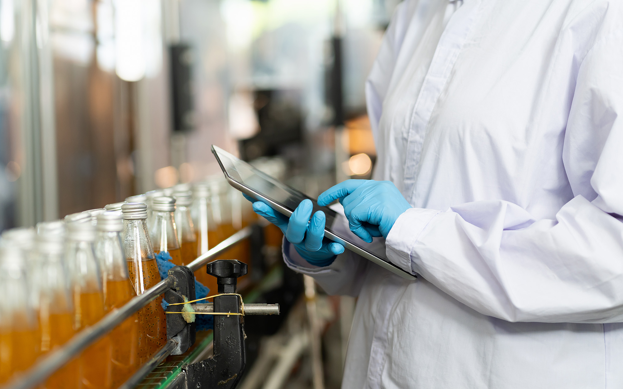 Hands of worker working with digital tablet check product on the conveyor belt